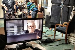 Actor Stephen Lang on the monitor (and behind the desk) on the double-duty set of "The Girl on the Train."