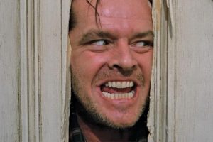 shot from "The Shining" with the main character looking through a broken door.