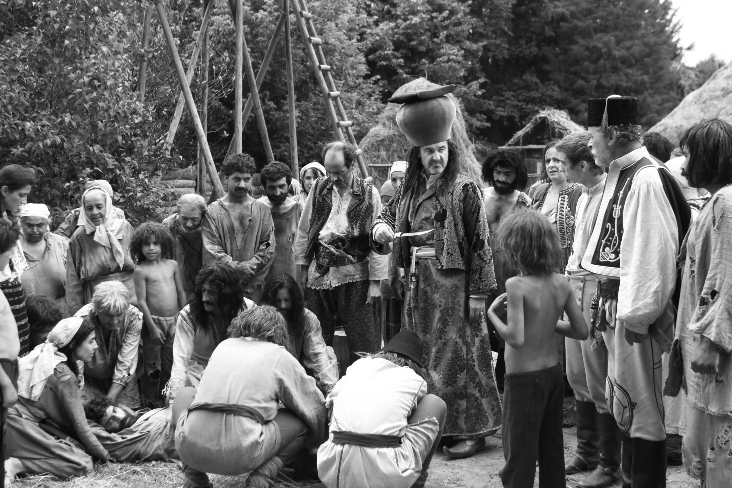 a screengrab from the movie with a group of people in a village