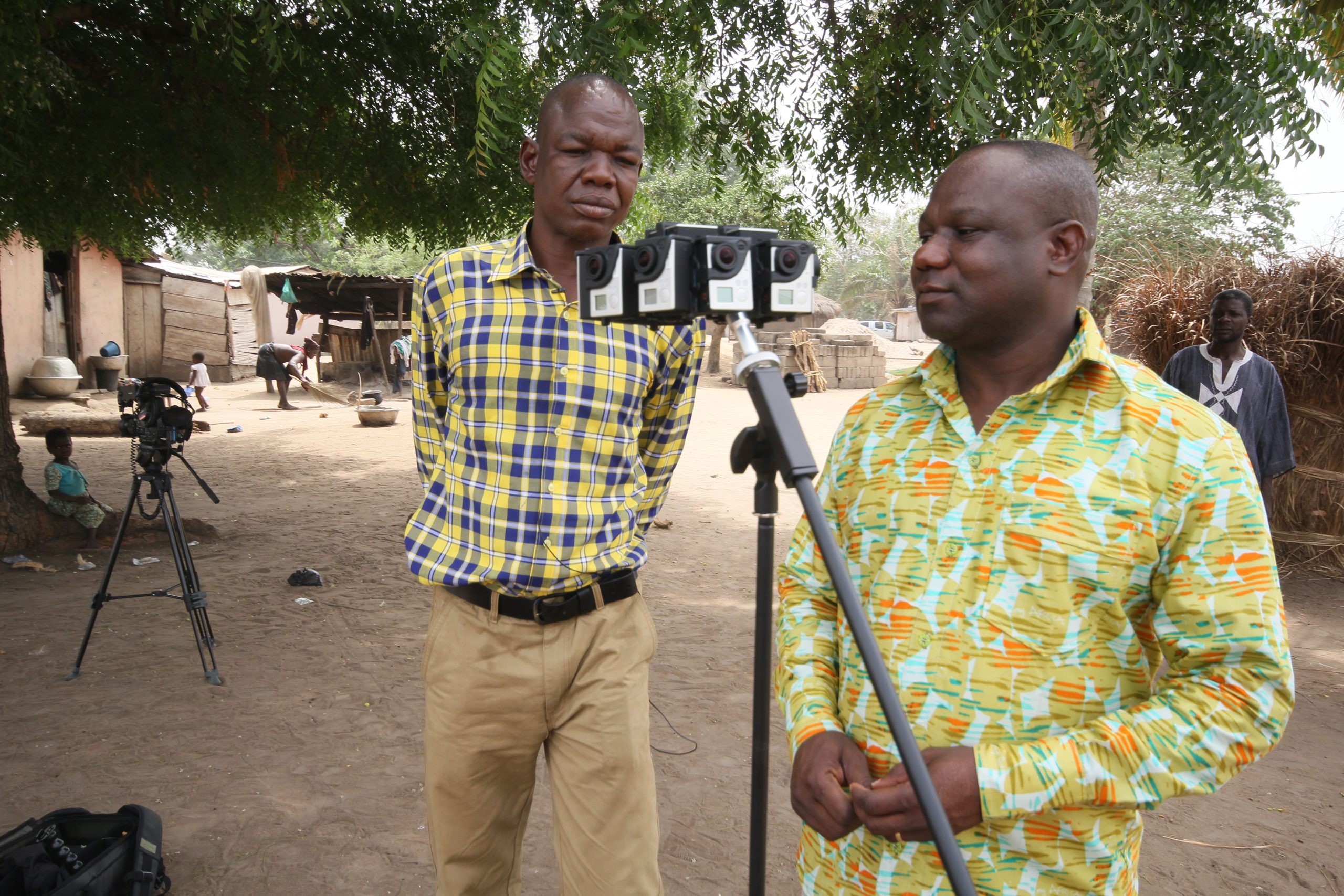 Two men film outdoors