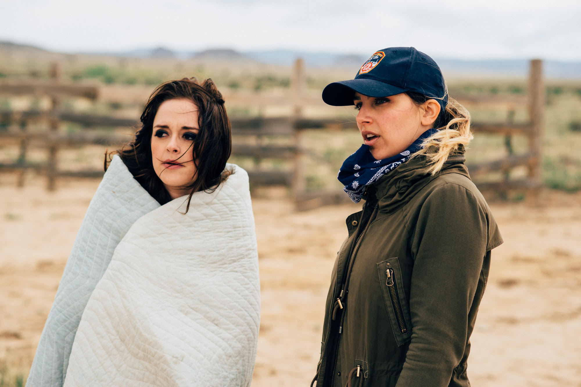 Lauren Carter using a blanket with Director Natasha Kermani on a coat in the set of Imitation Girl