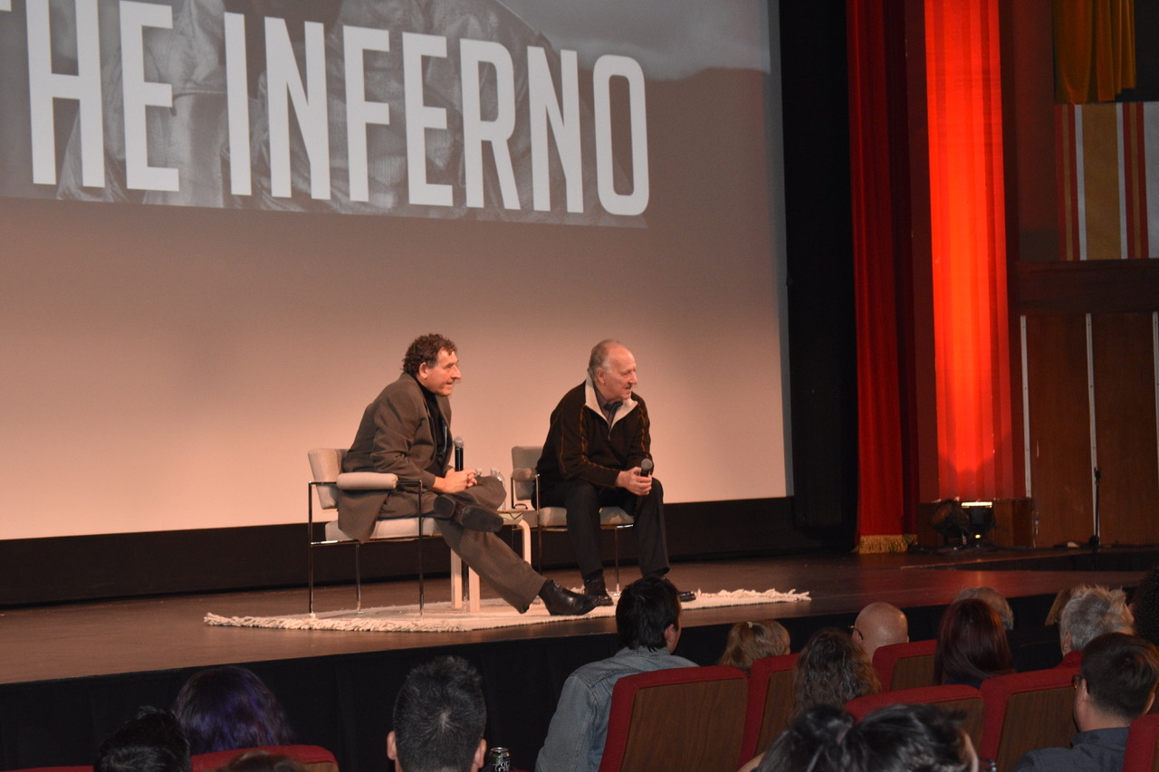 Title of The Inferno on the theater screen. Werner Herzog looking and answering questions from the audience.