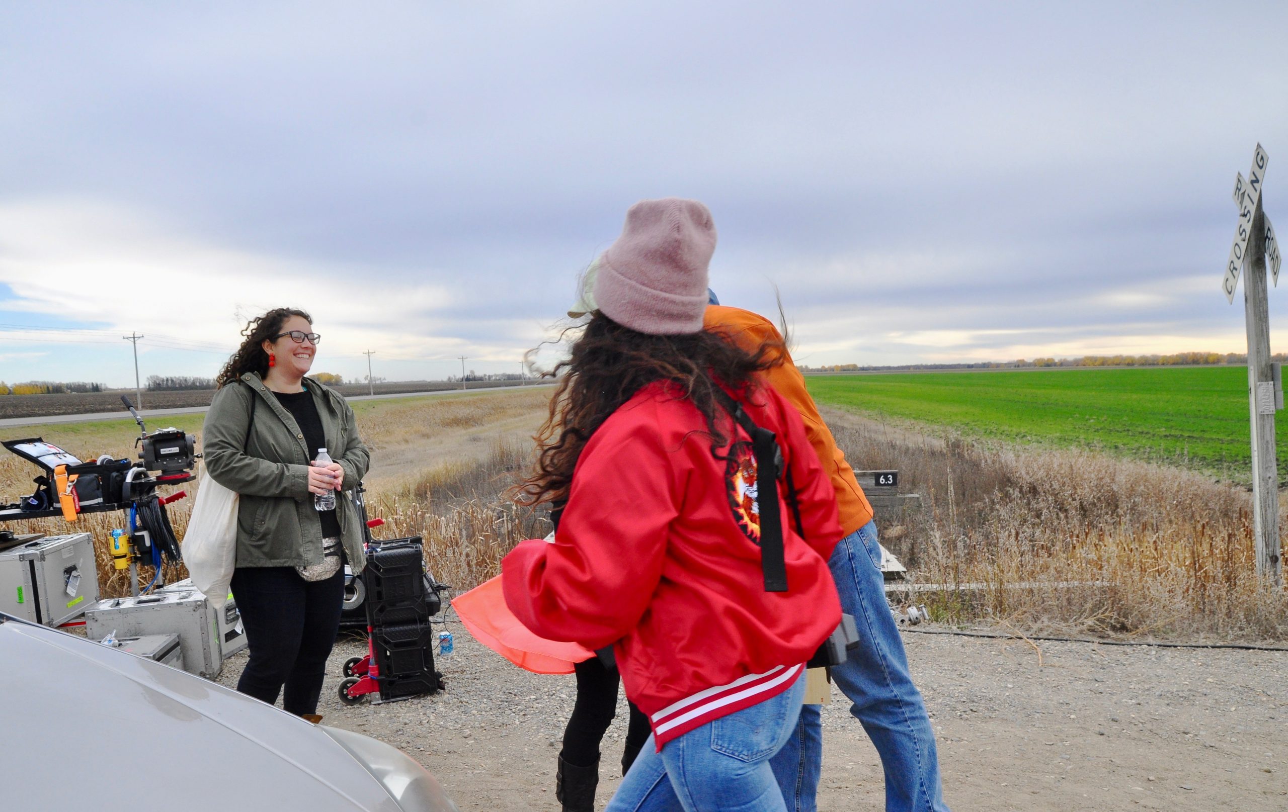 Two woman outdoors and on set.