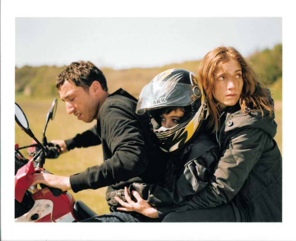 Three people on a motorcycle.