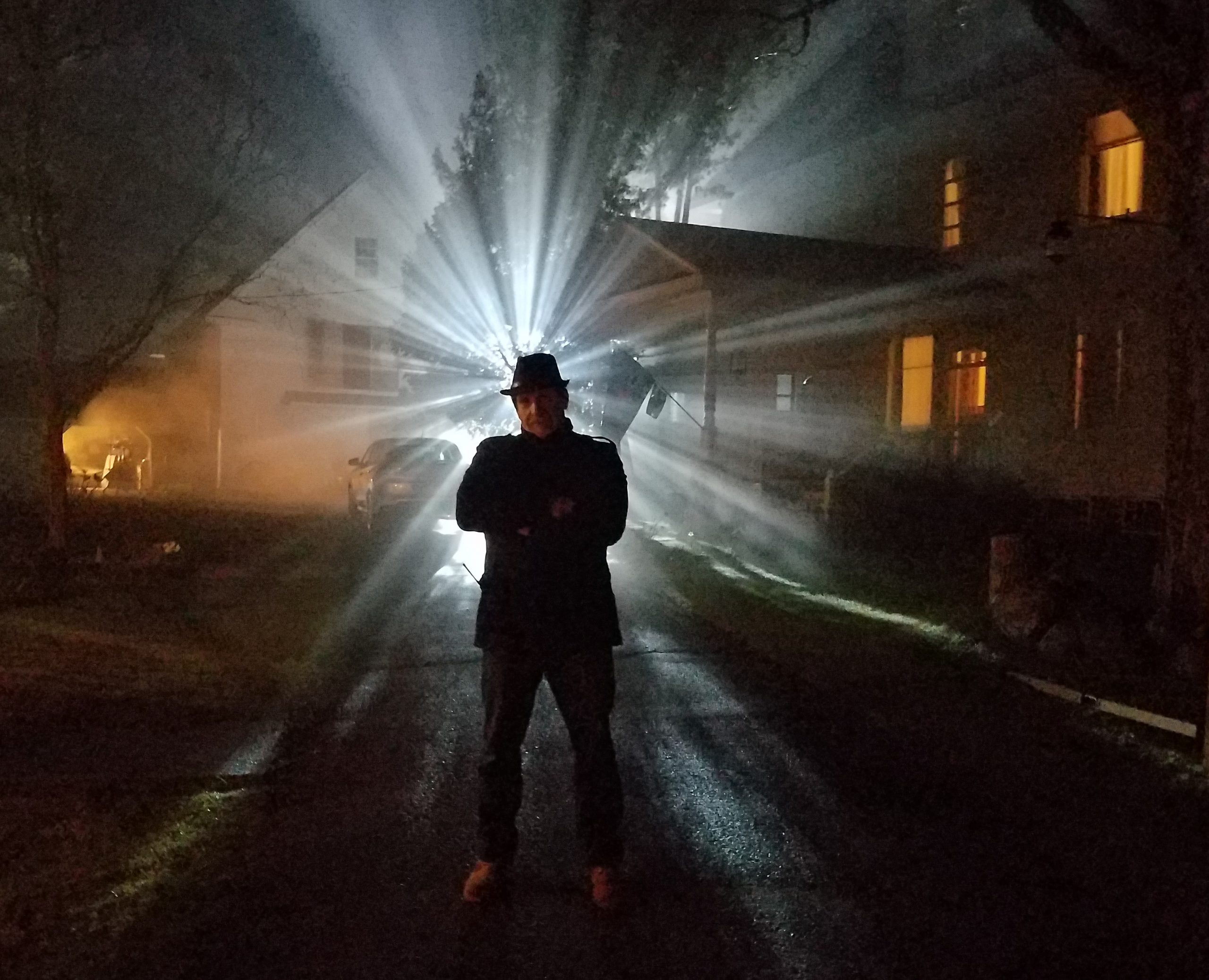 Producer Ed Polgary standing in silhouette on the set of The Wretched