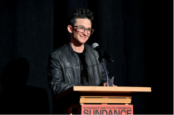 Director Sam Feder stands at a podium at the Sundance Film Festival