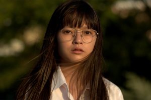 A still of a young Japanese girl with glasses and windswept hair from Maiko Endo's film Tokyo Telepath 2020
