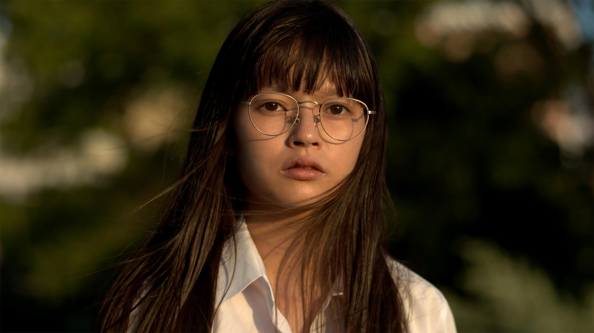 A still of a young Japanese girl with glasses and windswept hair from Maiko Endo's film Tokyo Telepath 2020