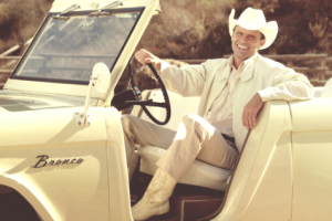 John Bronco (Walton Goggins) sitting in his jeep.