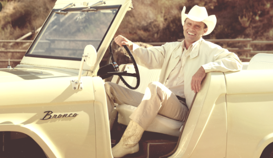 John Bronco (Walton Goggins) sitting in his jeep.