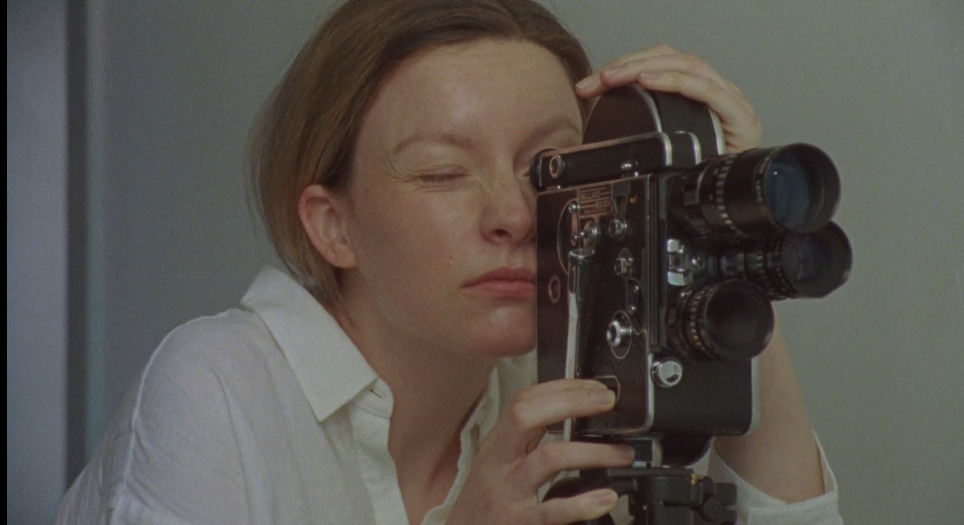 WOMAN WITH BOLEX CAMERA