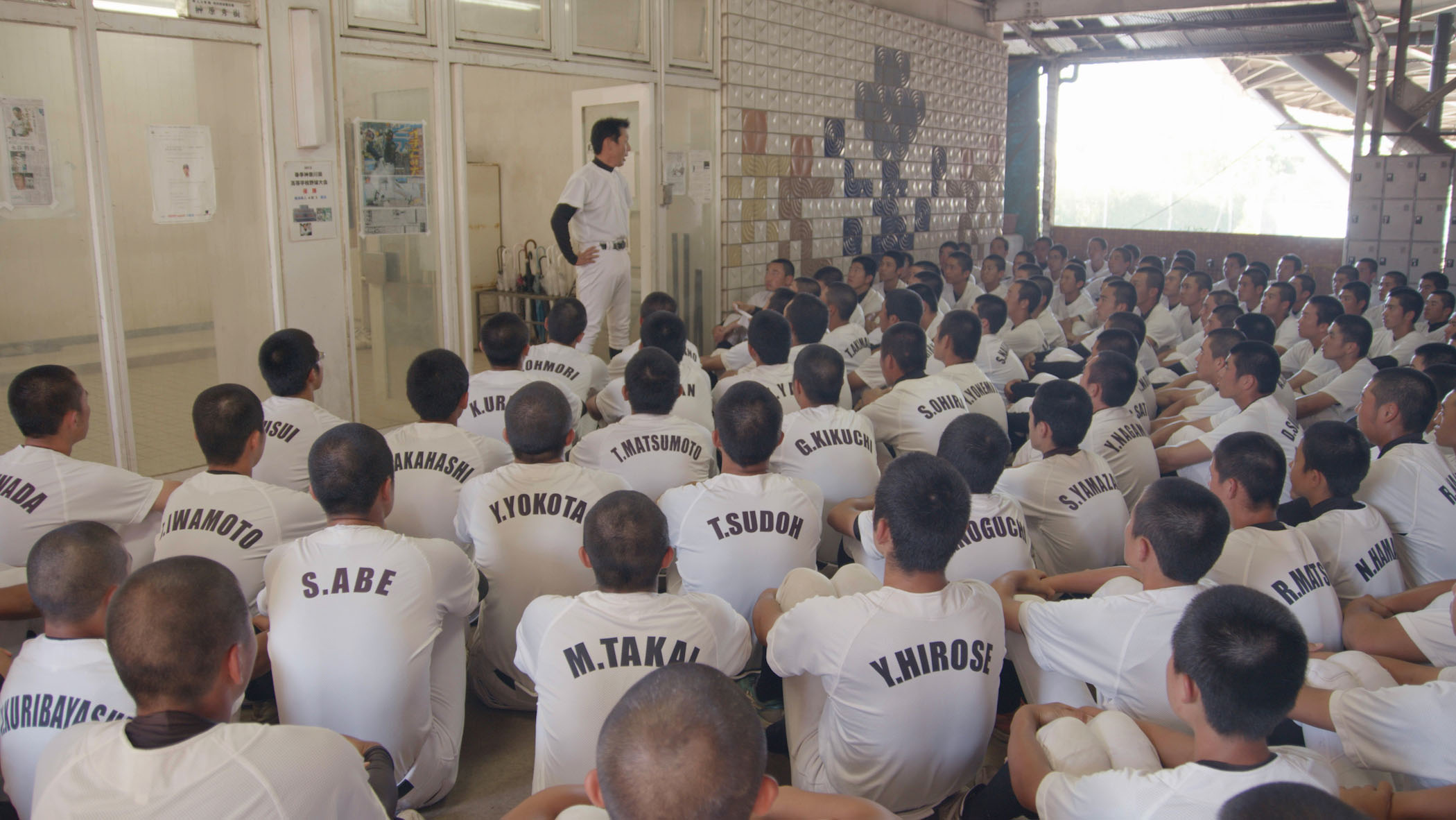 Baseball players listen to their coach.