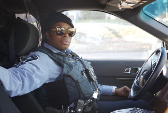 Black policewoman in car