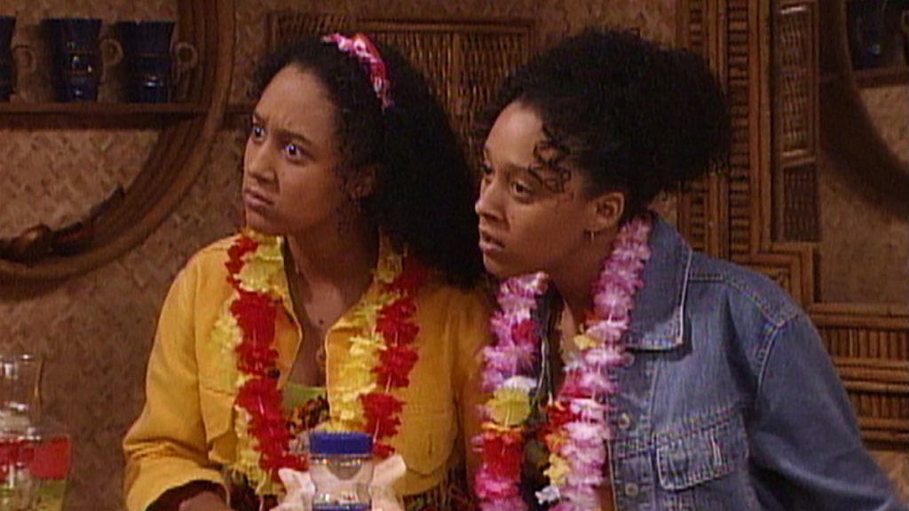 Twin sisters wearing leis. 