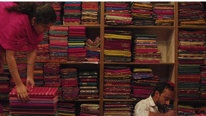 Wife & husband with fabric in shop