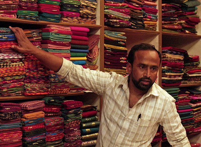 Husband with fabric in his shop