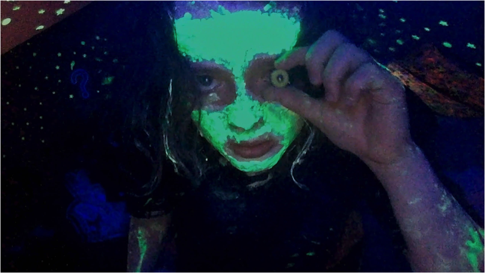 Photo of woman with glow-in-the-dark paint.