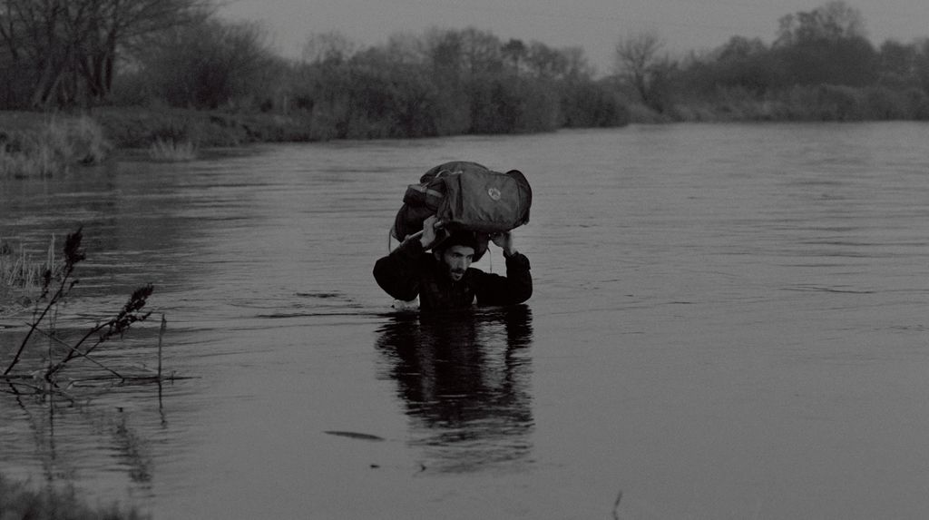 Man carrying package in water