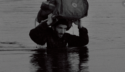 Man carrying package in water
