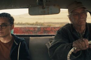 A trans man and his father sit in a pick up truck.