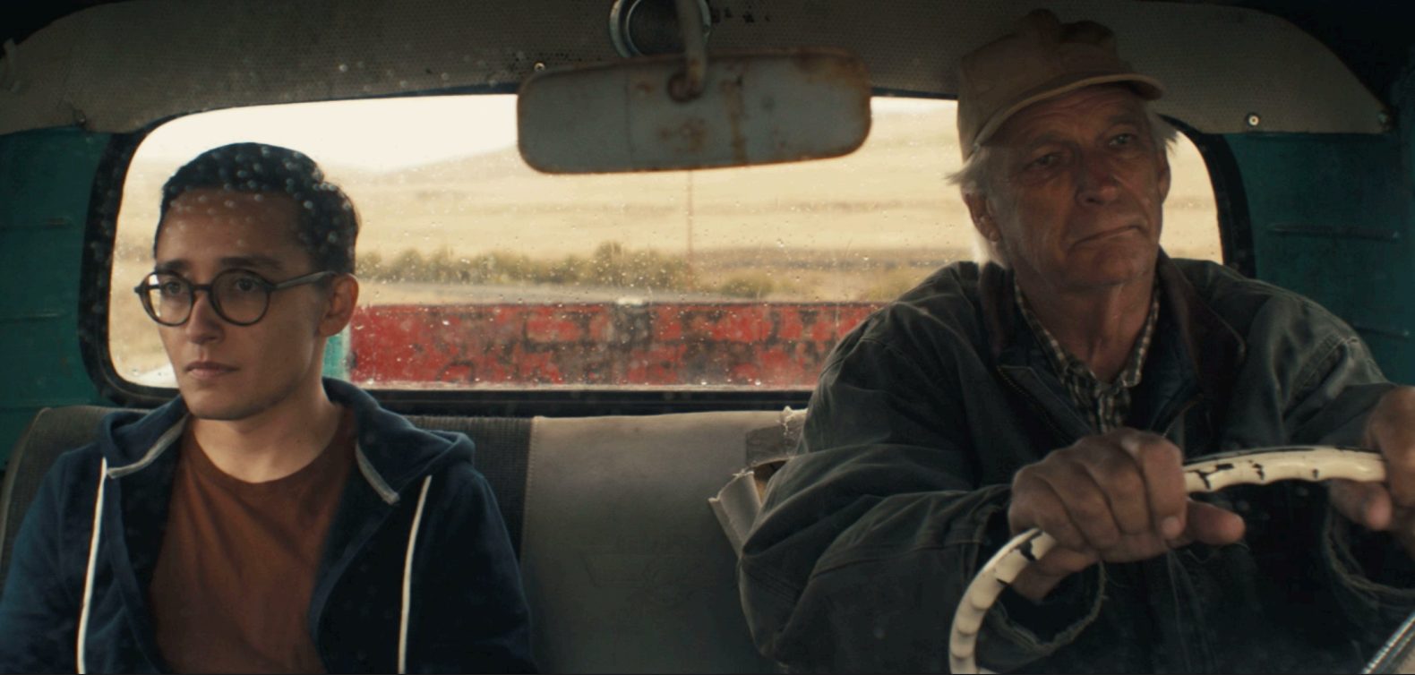 A trans man and his father sit in a pick up truck.