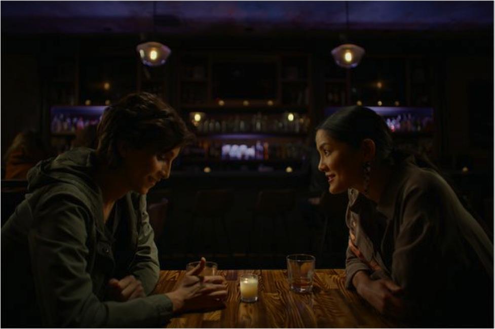 Two women sitting at a restaurant.