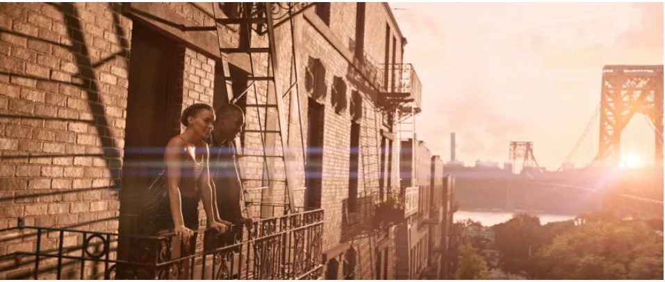 A man and woman on a fire escapte staring out at morning in New York City.