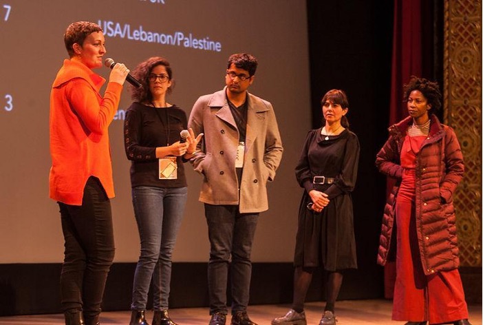 Five people standing on stage.