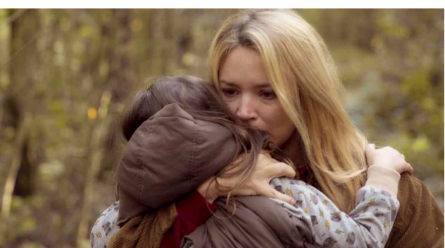Virginie Efira hugging child.