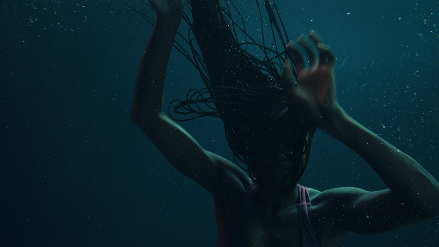 Woman drowning underwater.