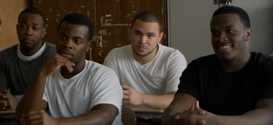young men talking to comedian Leguizamo at Rikers.