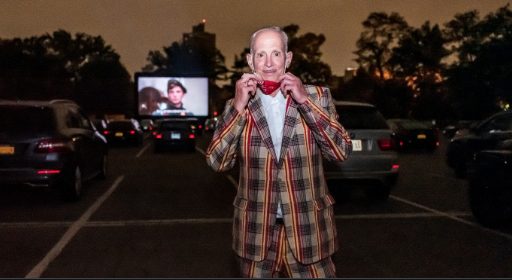 John Waters standing in front of a Queen's Drive-In