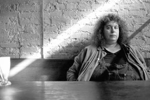 Woman sitting at a table.