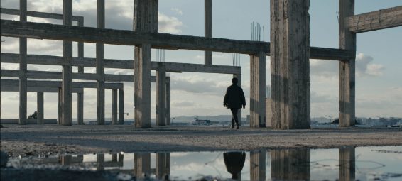 Woman walking through construction site.