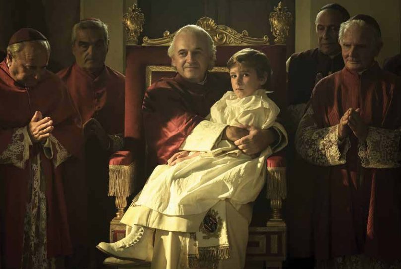 Boy on Pope's lap.
