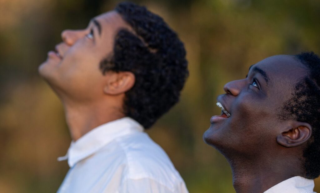 Brandon Wilson and Ethan Herisse staring up from the film Nickel Boys.