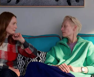 Julianne Moore and Tilda Swinton sitting on a sofa.