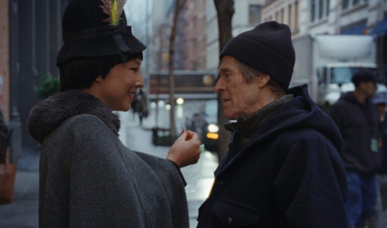 GRETA LEE AND WILLEM Dafoe on the street.