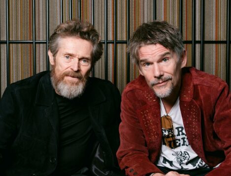 Willem Dafoe with Ethan Hawke sitting next to one another.
