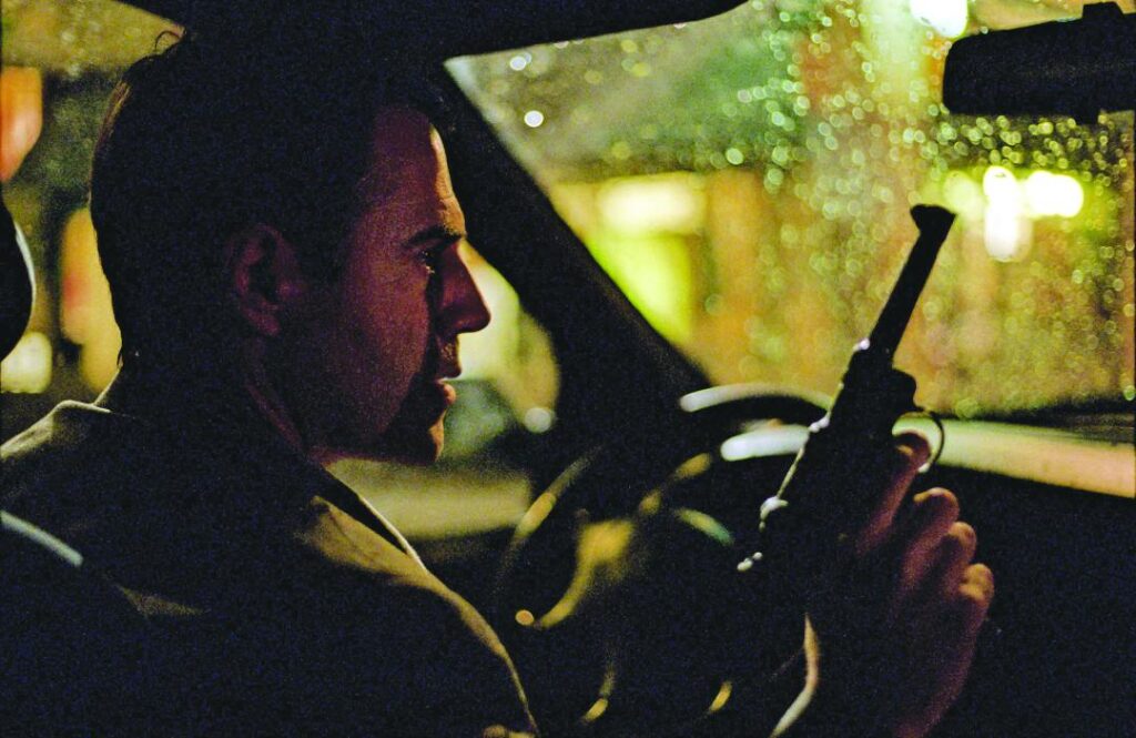 José Garcia sitting in car with gun.