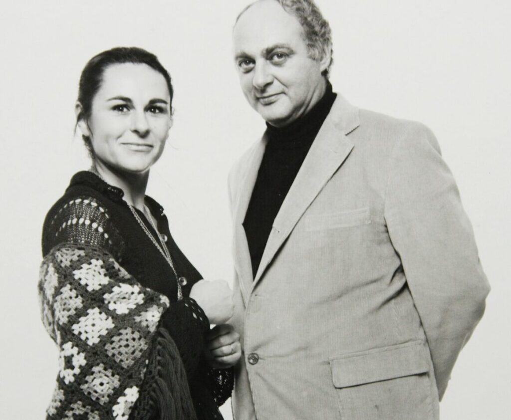 The Talbots standing next to one another in a press photo.