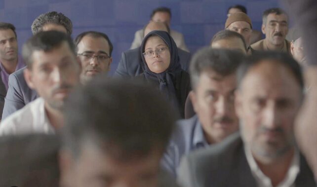 Woman surrounded by men.