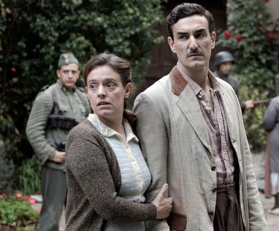 Two people surrounded by soldiers.