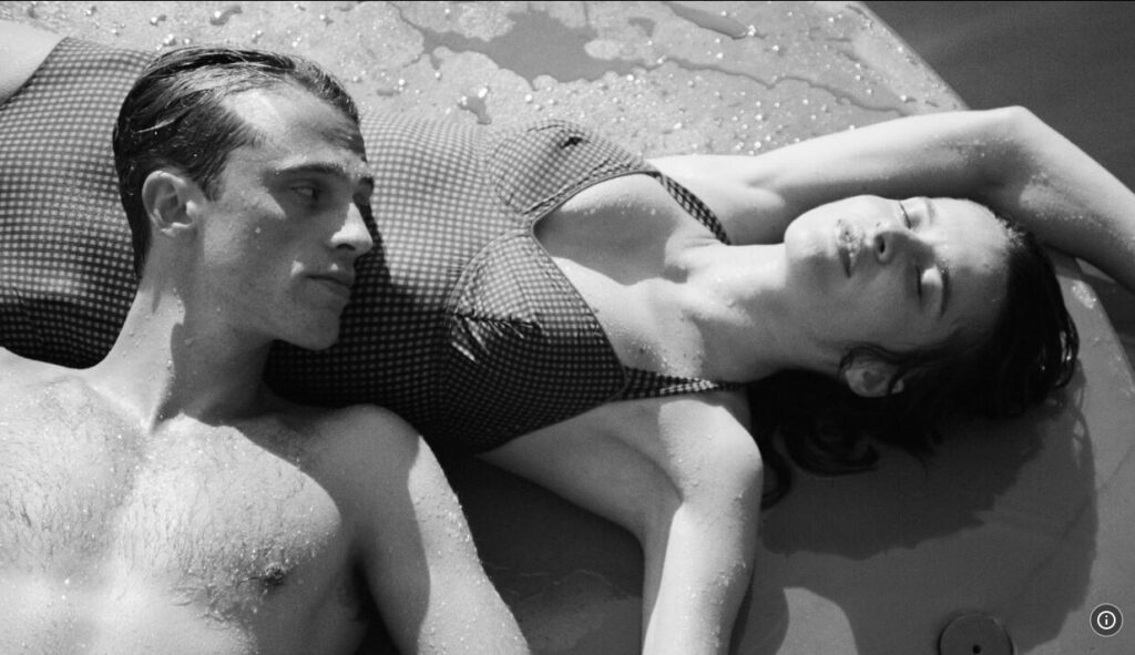 Man lying on woman in swimsuits.