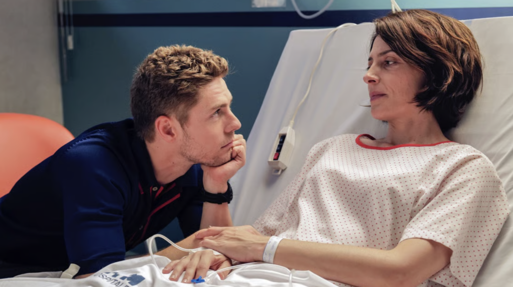 Two people in hospital room.