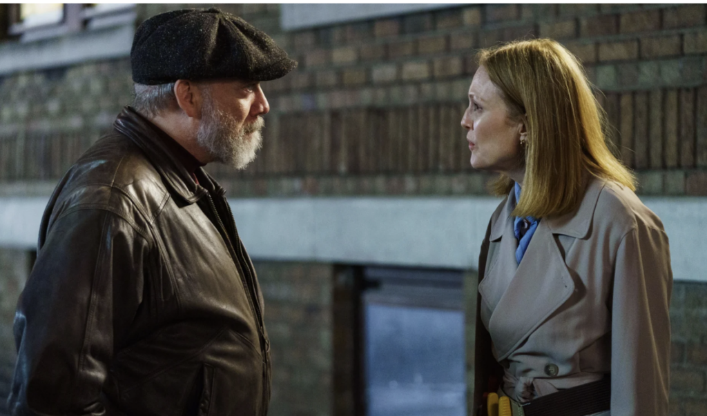 Paul Giametti and Julianne Moore talk on street.