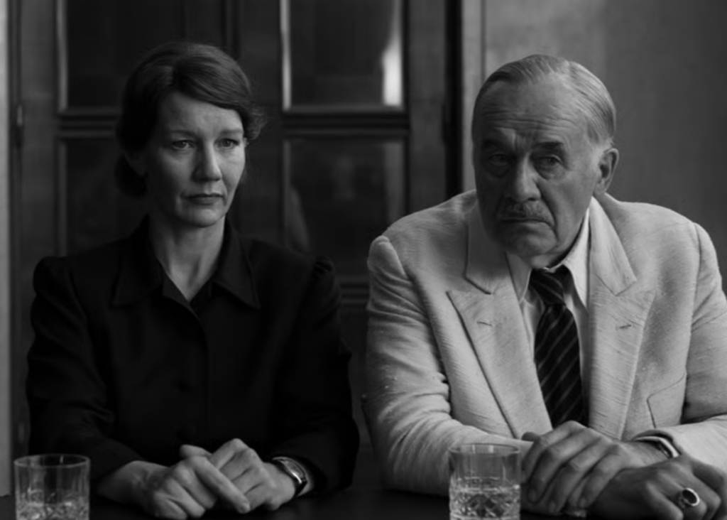 Sandra Muller and Hanns Zischler
sit side by side.